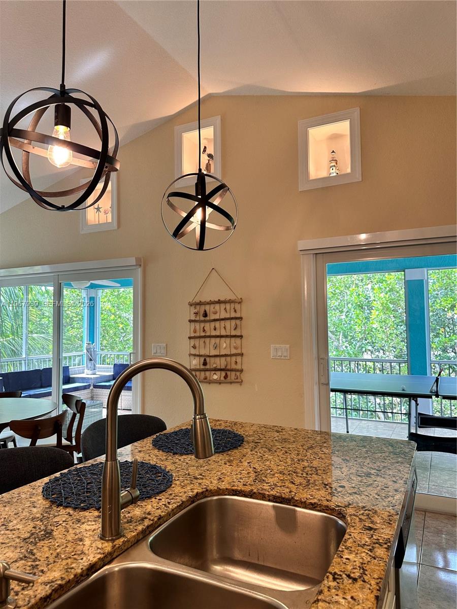 24 Tarpon Avenue Key Largo, FL 33037 - Photo 7 of 22 a kitchen with a table chairs and window
