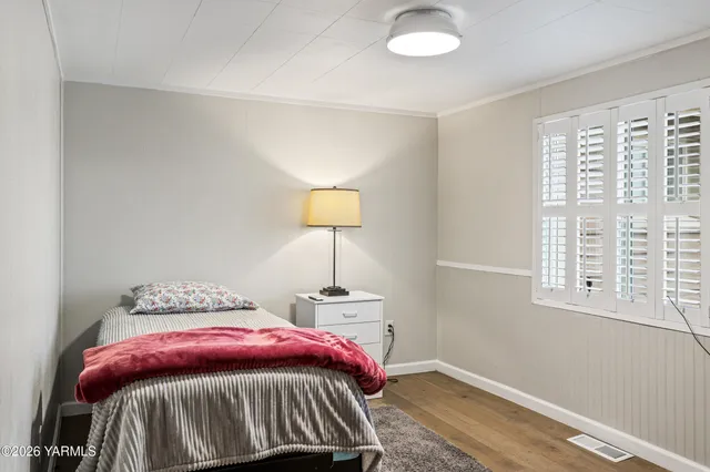 a front view of a house with a yard and potted plants