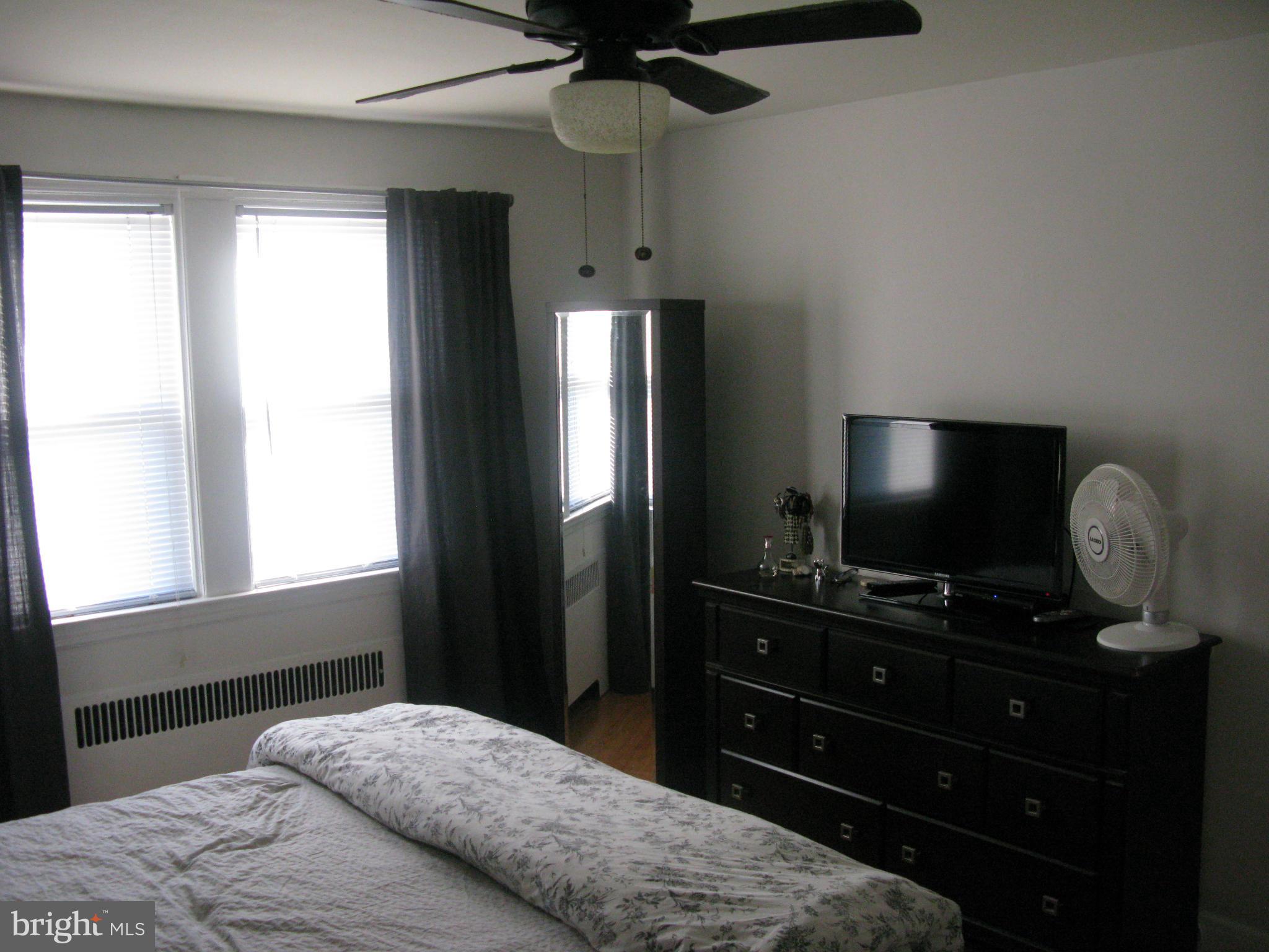 60 Murdock Road Baltimore, MD 21212 - Photo 14 of 30 a bedroom with a bed and a flat screen tv