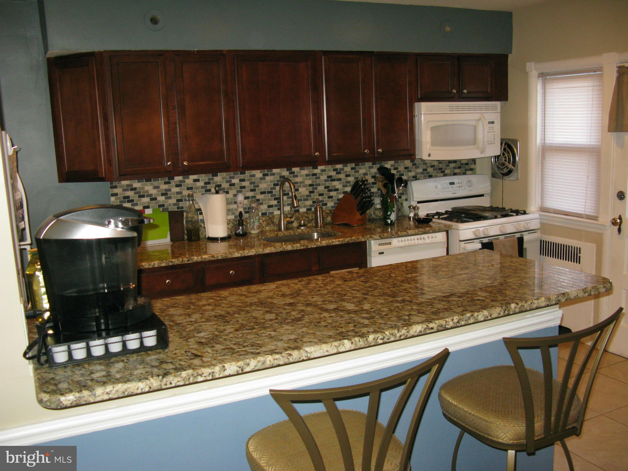 60 Murdock Road Baltimore, MD 21212 - Photo 7 of 30 a kitchen with a table chairs and cabinets