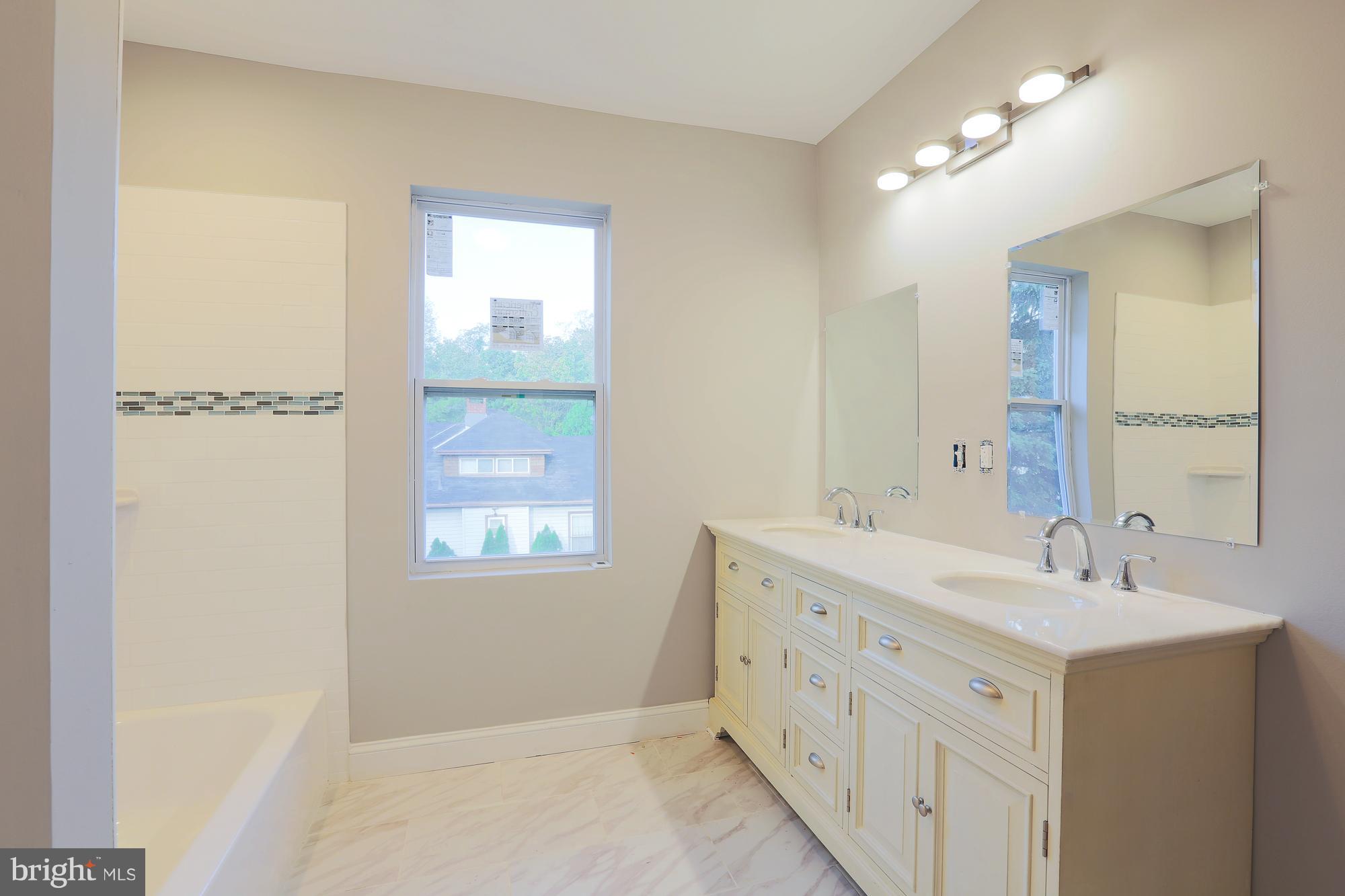 4216 Ridgewood Avenue Baltimore, MD 21215 - Photo 11 of 29 Upstairs bath features double vanity and full bath