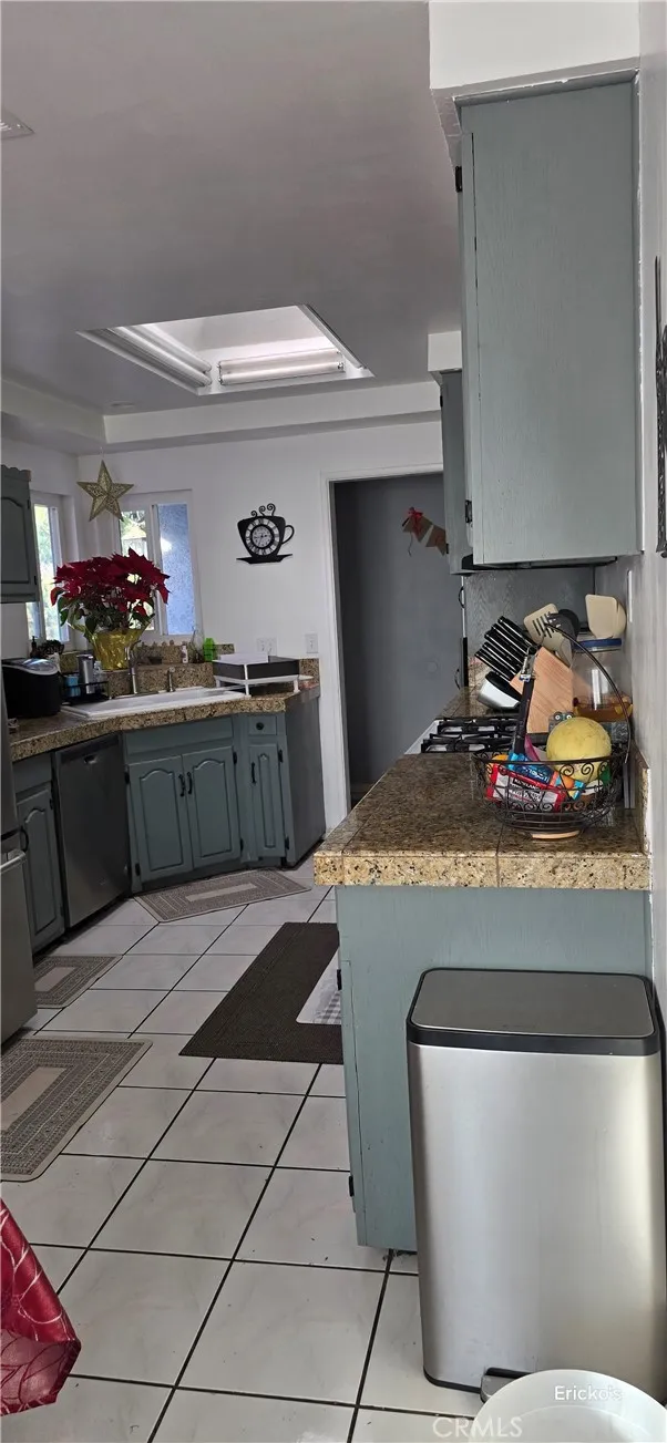 240 East Shady Grove Drive Riverside, CA 92507 - Photo 4 of 5 a kitchen with stainless steel appliances granite countertop a sink and cabinets