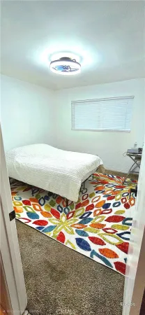 a room with a bed and chandelier
