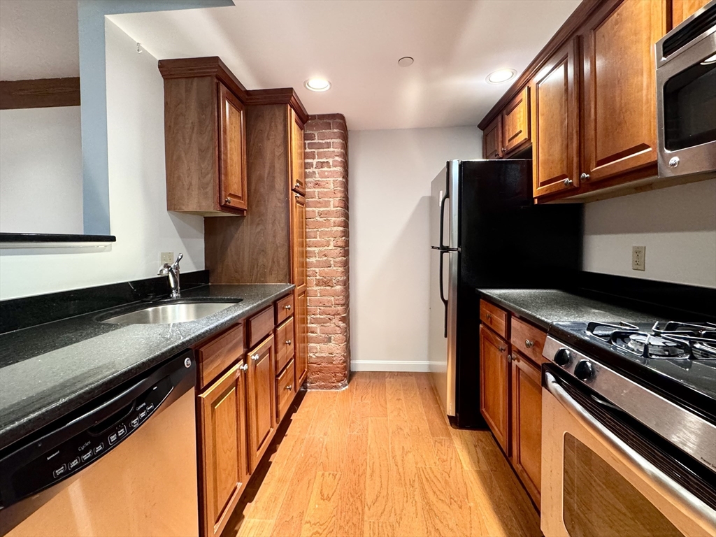 4 Bishop Street, Unit G11 Framingham, MA 01702 - Photo 1 of 24 a kitchen with stainless steel appliances a sink dishwasher stove and refrigerator