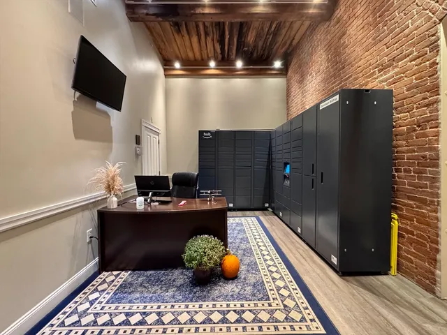 a kitchen with stainless steel appliances kitchen island granite countertop a refrigerator and a sink