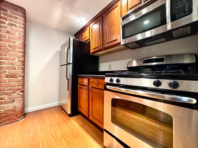 a stove top oven sitting inside of a kitchen
