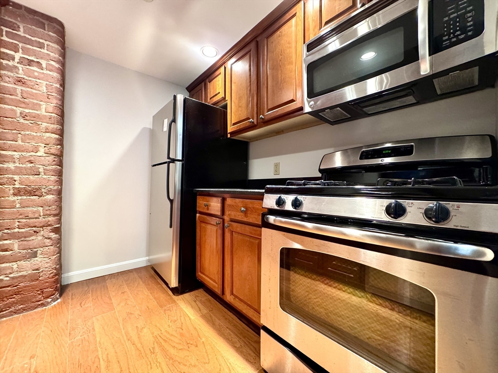 4 Bishop Street, Unit G11 Framingham, MA 01702 - Photo 2 of 24 a stove top oven sitting inside of a kitchen