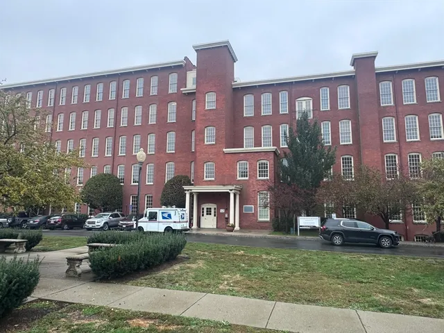 a front view of a building with a garden