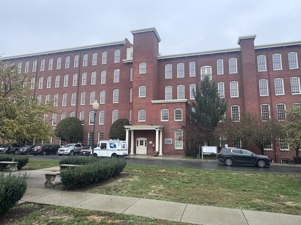 4 Bishop Street, Unit G11 Framingham, MA 01702 - Photo 24 of 24 a front view of a building with a garden