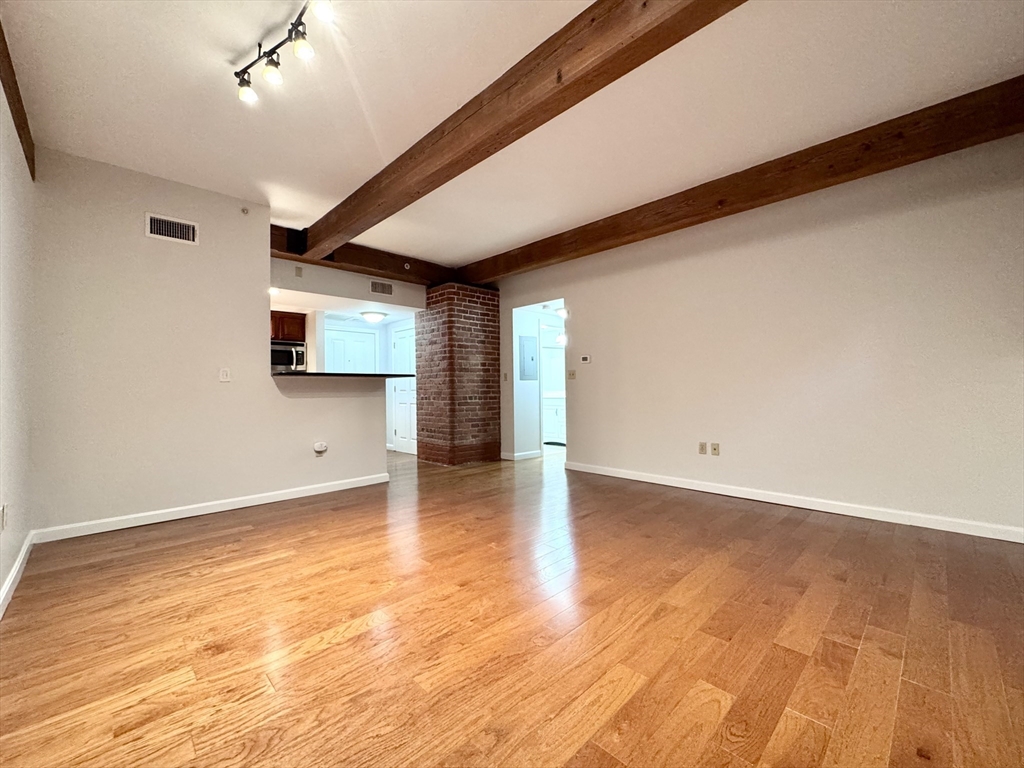 4 Bishop Street, Unit G11 Framingham, MA 01702 - Photo 9 of 24 a view of a livingroom with wooden floor and a window