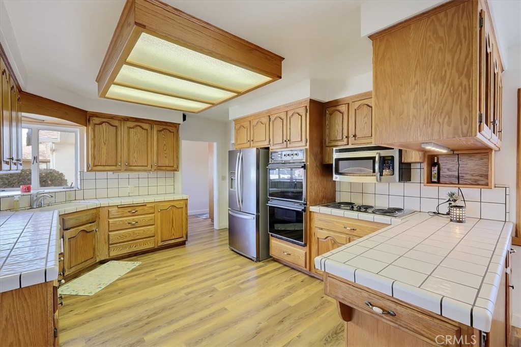 1255 Richvale Highway Richvale, CA 95974 - Photo 15 of 49 a kitchen with stainless steel appliances kitchen island granite countertop a refrigerator a stove and a sink with granite countertops