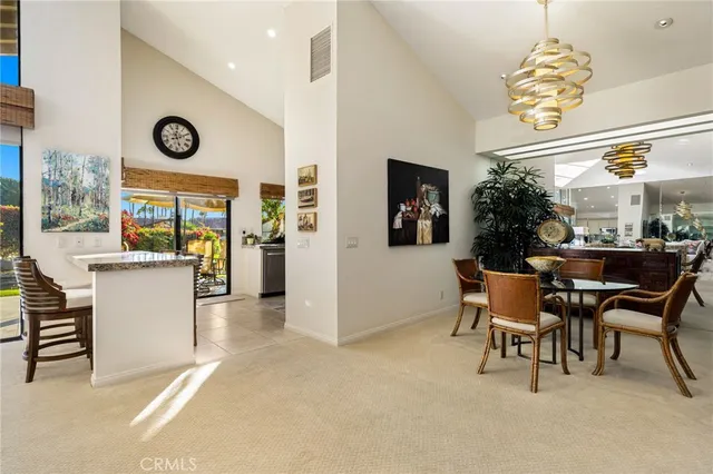 a view of a dining room with furniture and a chandelier