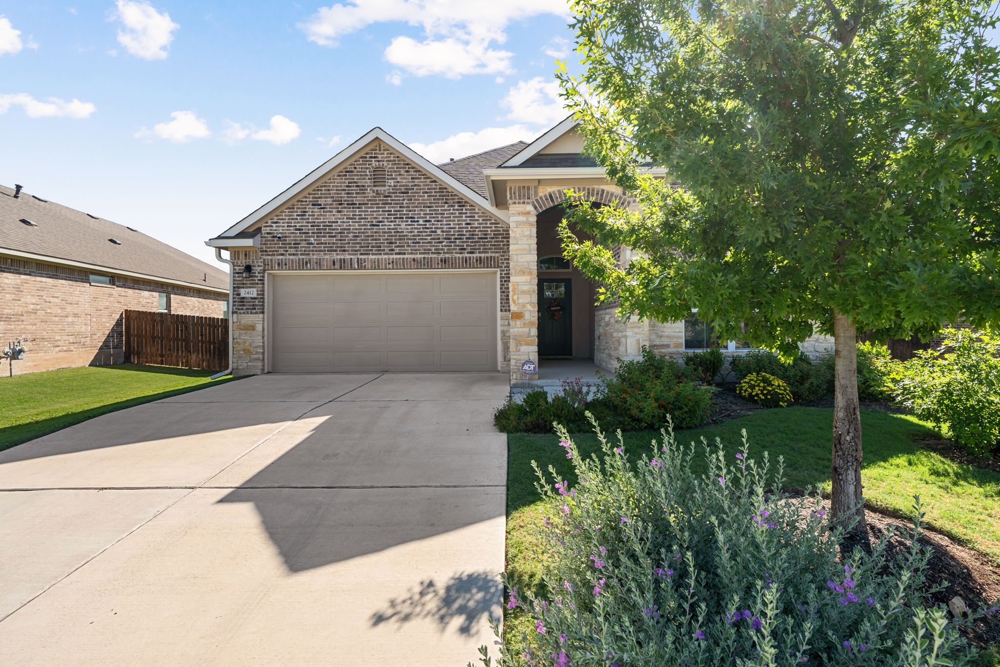 2412 Starhill Ranch Street Georgetown, TX 78628 - Photo 2 of 40 A well-maintained facade with a stone and brick exterior welcomes you home.