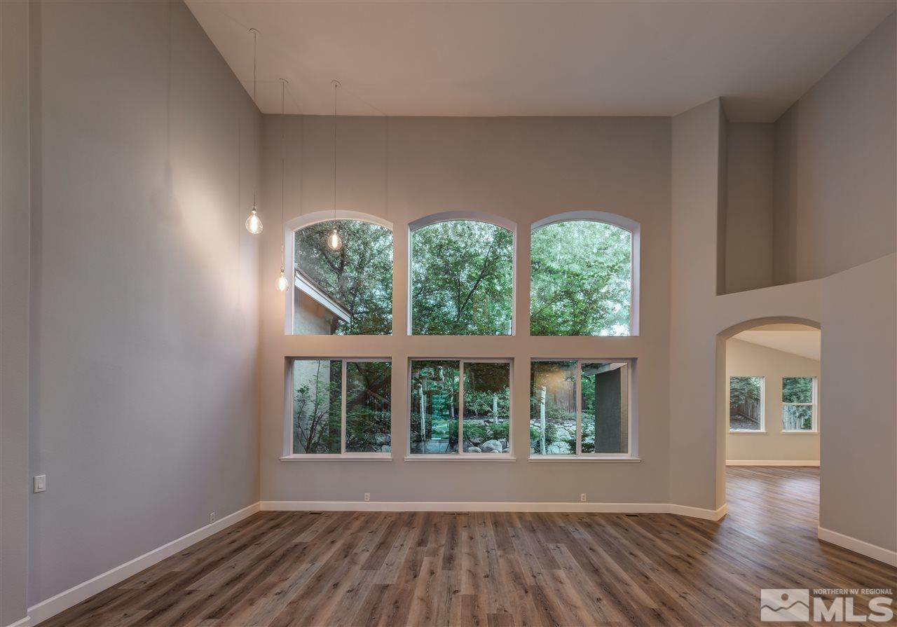 1858 Rombauer Court Reno, NV 89519 - Photo 5 of 19 an empty room with wooden floor and windows