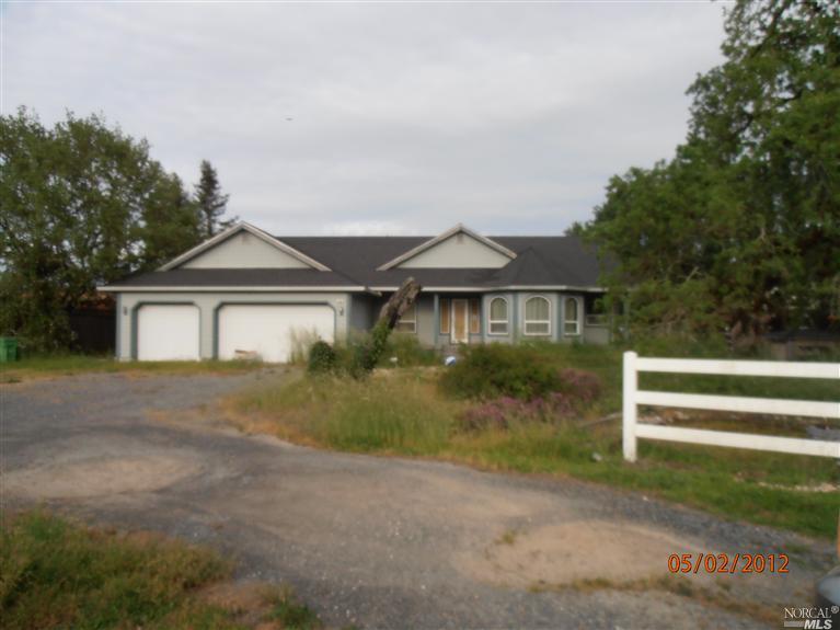 390 Laguna Vista Road Santa Rosa, CA 95401 - Photo 1 of 1 a front view of a house with a yard and garage