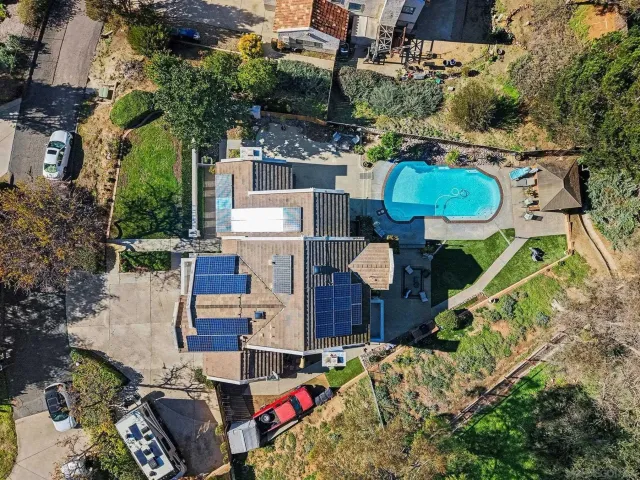 an aerial view of a house with a yard and garden