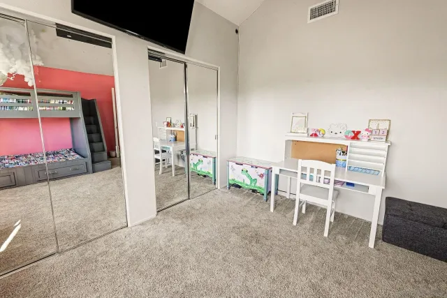 a dining room with furniture and a floor to ceiling window