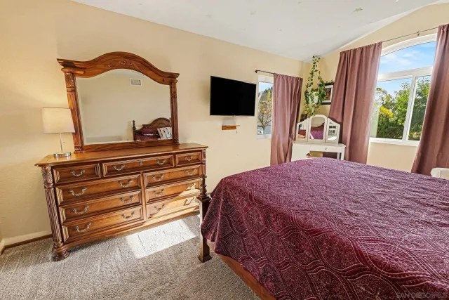 a bedroom with a bed and window