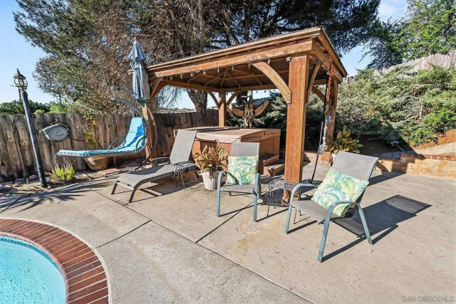 an outdoor sitting area with couch and garden