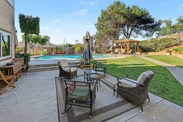 a view of a chairs and table in backyard