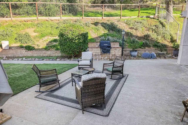 a view of a backyard with sitting area