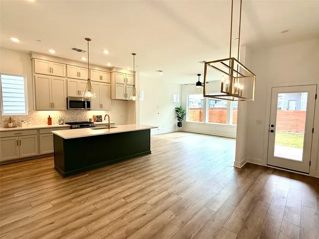 a kitchen with stainless steel appliances kitchen island wooden cabinets and granite counter tops