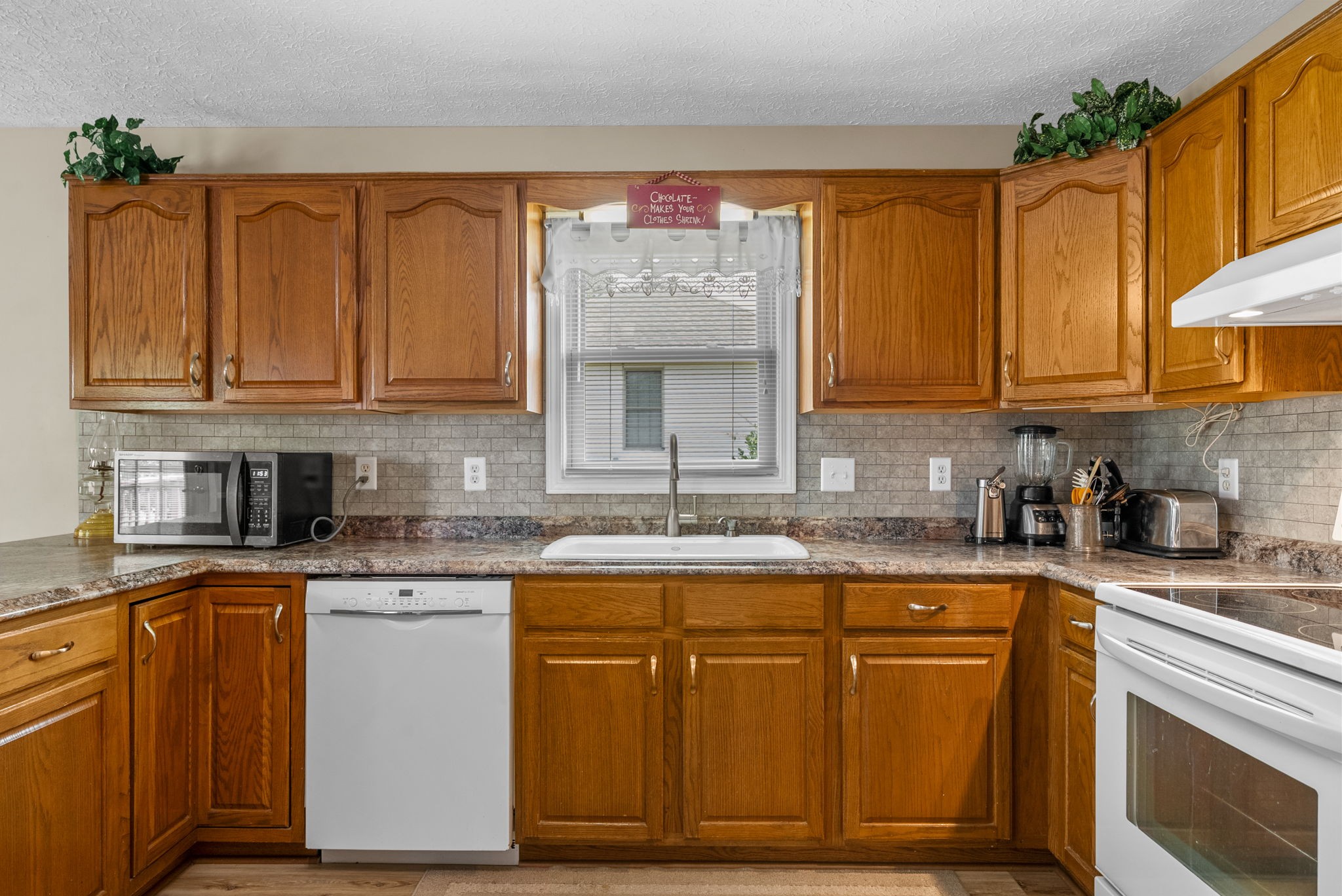 1230 Bark Ridge Circle Hopkinsville, KY 42240 - Photo 11 of 38 a kitchen with stainless steel appliances granite countertop a sink stove and cabinets
