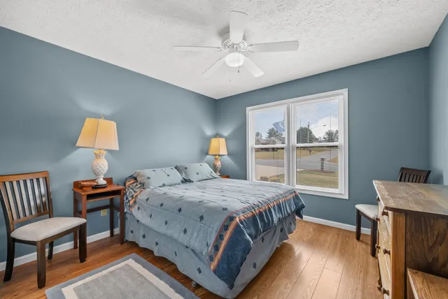 a bedroom with a bed and a table in it