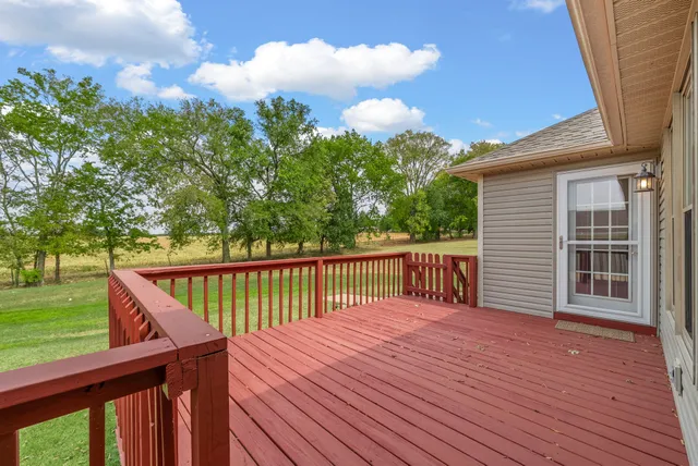a balcony with wooden floor and fence