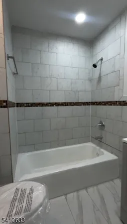 a bathroom with a bathtub and shower