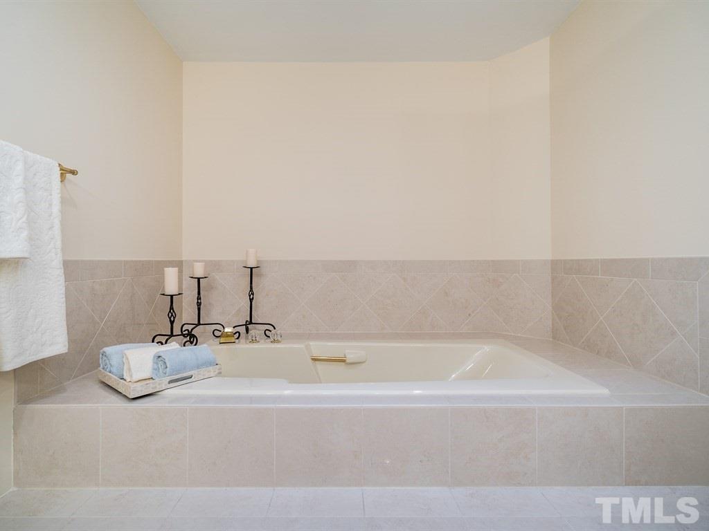 10000 Grafton Road Raleigh, NC 27615 - Photo 16 of 25 Enjoy large garden tub surrounded by 12 inch porceline tiles around tub and on flooring.