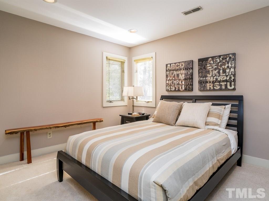 10000 Grafton Road Raleigh, NC 27615 - Photo 18 of 25 One of the spacous secondary bedrooms. Each of these bedrooms offers recessed lighting and neutral carpeting.