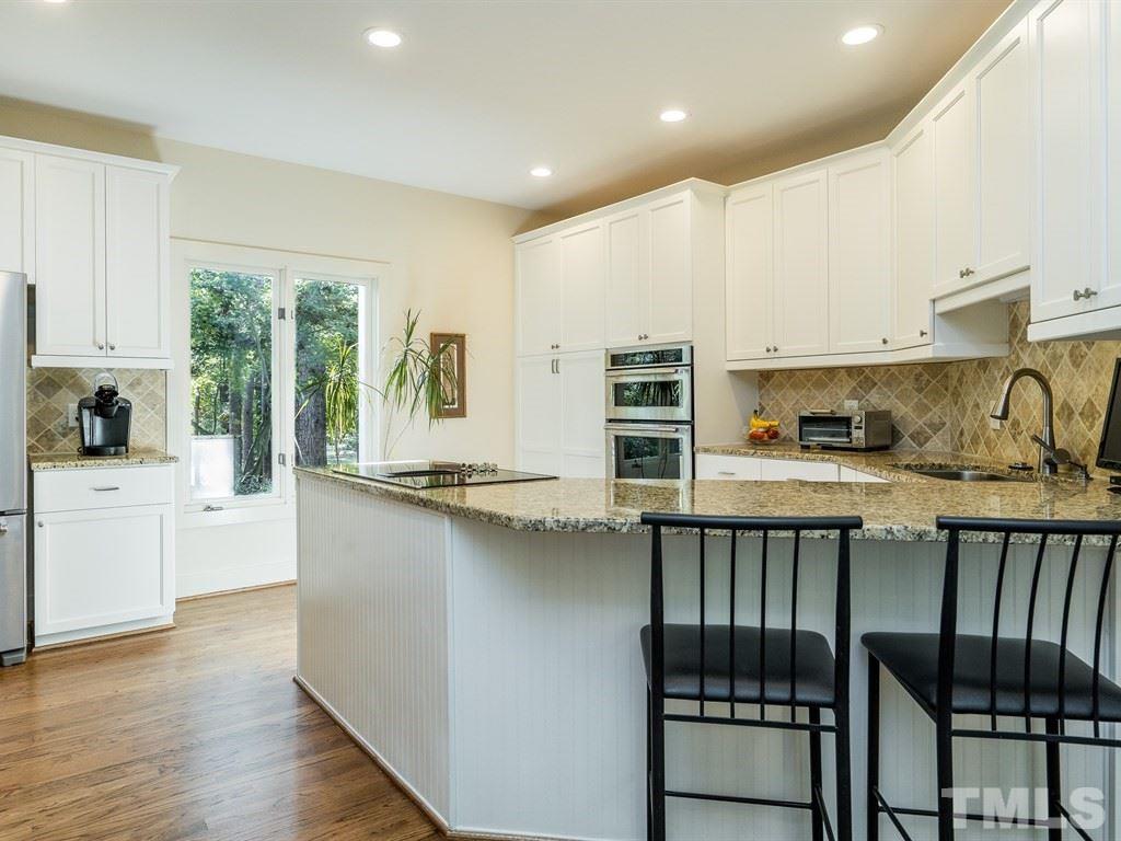 10000 Grafton Road Raleigh, NC 27615 - Photo 5 of 25 Remodeled kitchen with shaker style soft close cabinets, wood flooring, granite counters, new stainless steel appliances, undermount and recessed lighting.
