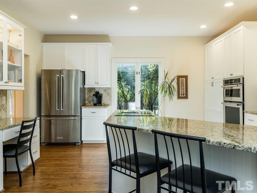 10000 Grafton Road Raleigh, NC 27615 - Photo 6 of 25 Large peninsula, with rm for 2-3 barstools. Great flow for entertaining. Desk with glass display cabinets & light. The kitchen and breakfast areas extend from the front of the home to the rear enabling morning and afternoon sunlight.
