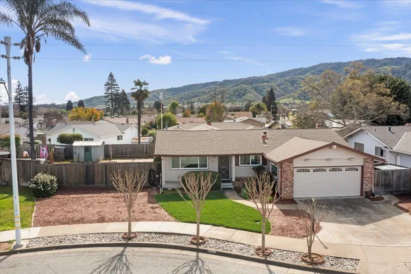 a view of a patio with a table and chairs