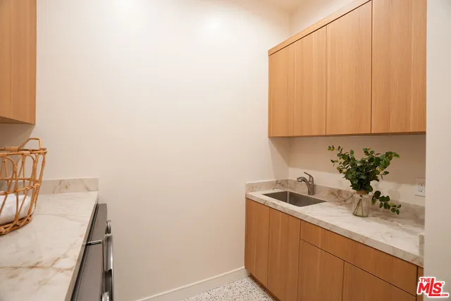 a bathroom with a sink and cabinets