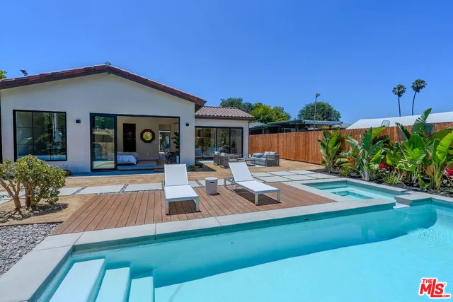 a view of a house with swimming pool and sitting area