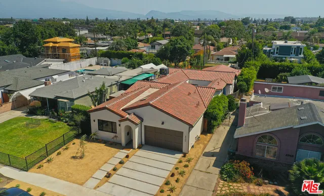 an aerial view of multiple houses with yard