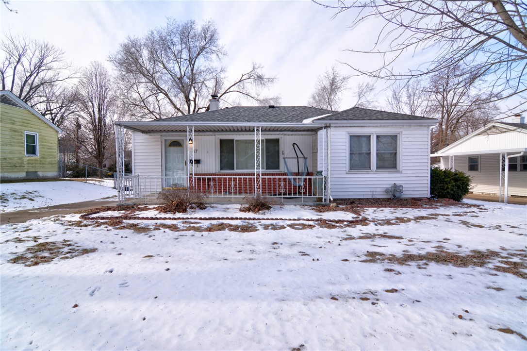 47 1st South Shores Avenue Decatur, IL 62521 - Photo 1 of 24 a front view of a house with a dirt yard and a large tree