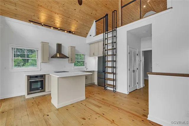 a kitchen with granite countertop a stove and a wooden floors
