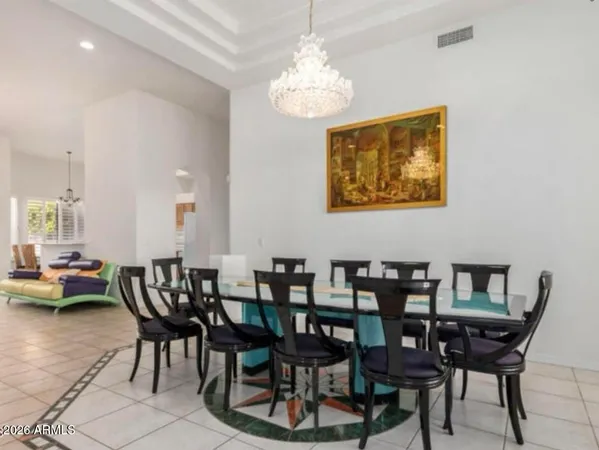 a view of a dining room with furniture and chandelier
