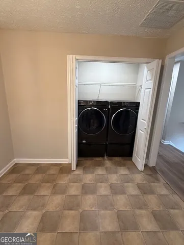 a bathroom with a sink and a washer dryer