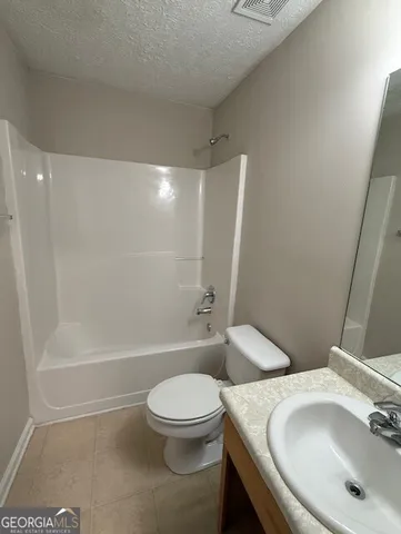 a bathroom with a toilet a sink and bathtub