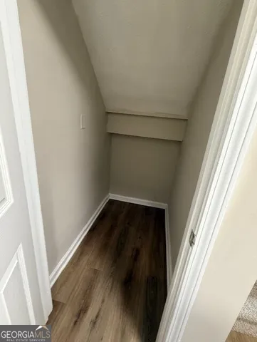 a view of a small space with wooden floor and porch