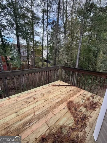 a view of wooden fence and trees around