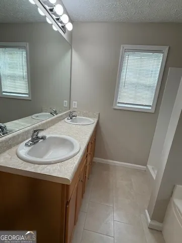 a bathroom with a sink a vanity and a mirror