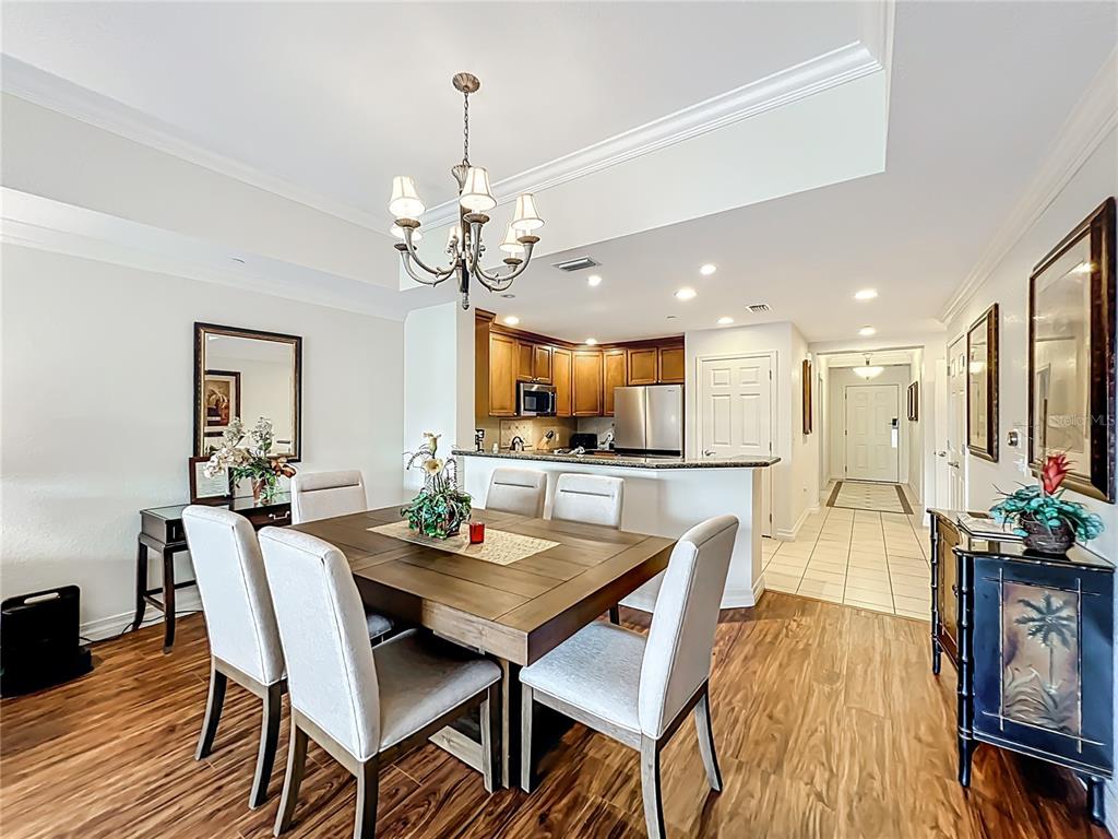 7660 Whisper Way, Unit 402 Reunion, FL 34747 - Photo 15 of 65 a view of a dining room with furniture and wooden floor