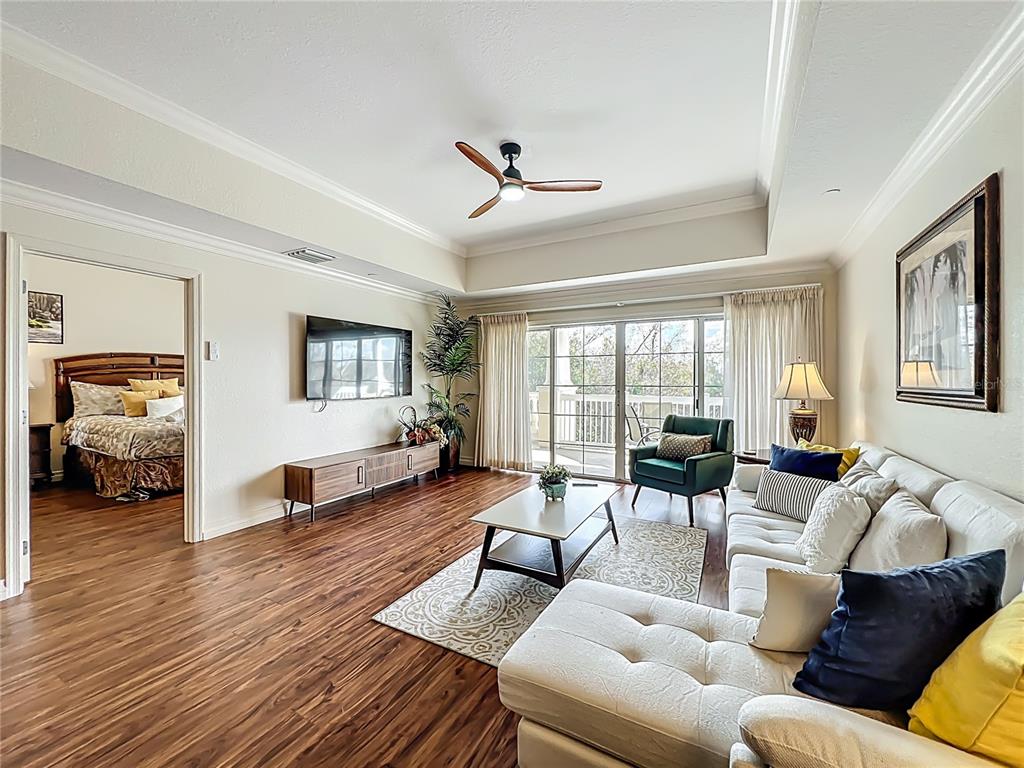 7660 Whisper Way, Unit 402 Reunion, FL 34747 - Photo 17 of 65 a living room with furniture and a large window