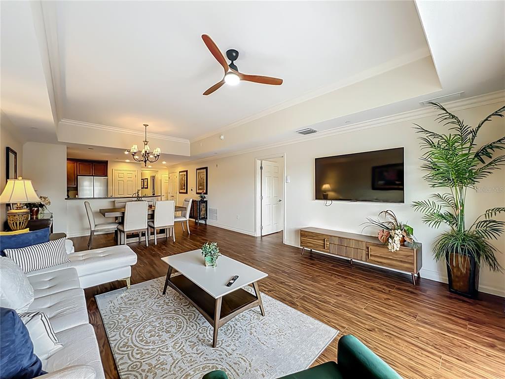 7660 Whisper Way, Unit 402 Reunion, FL 34747 - Photo 18 of 65 a living room with furniture and a flat screen tv
