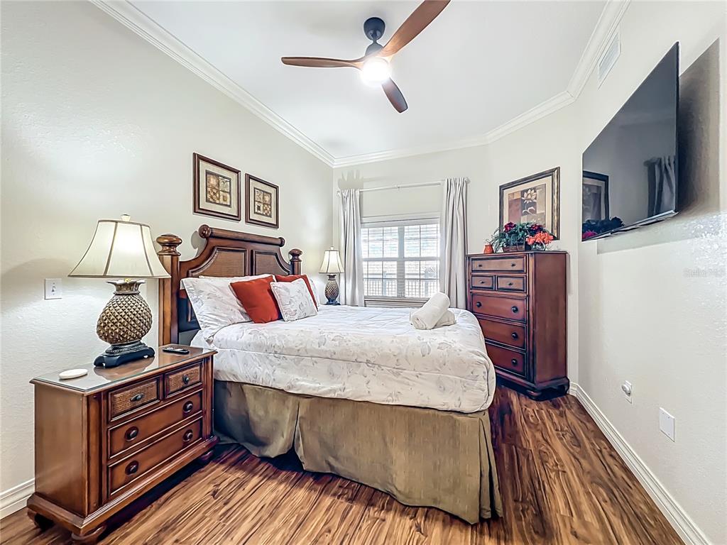 7660 Whisper Way, Unit 402 Reunion, FL 34747 - Photo 21 of 65 a bed room with bed and window